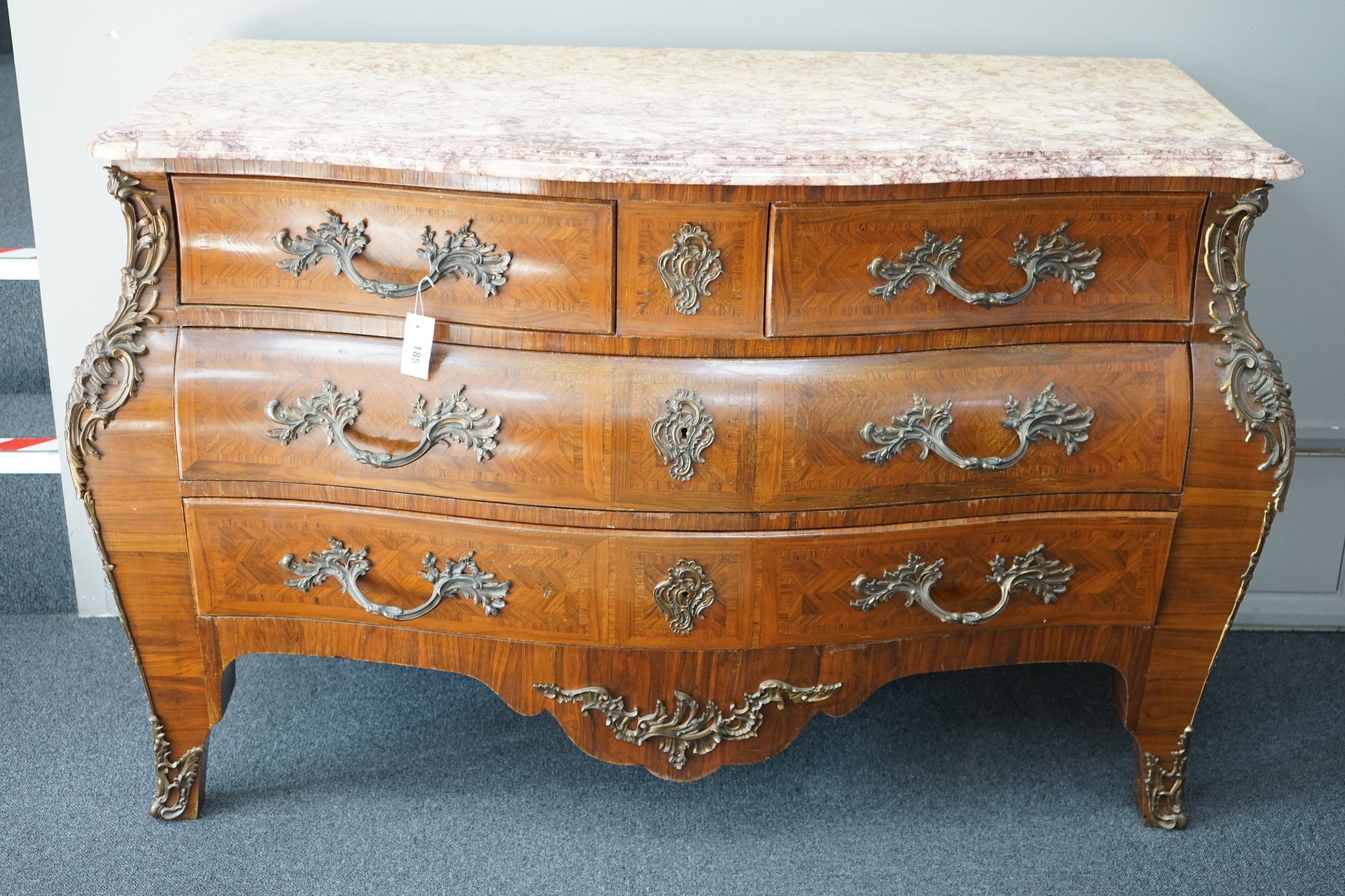 A Louis XV style marble topped serpentine bombe commode - impressed maker's stamp, M.P., width 140cm, depth 59cm, height 90cm